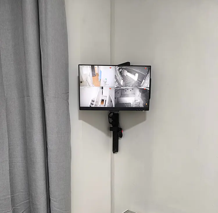 Wall-mounted CCTV monitor displaying live camera feeds in a residential property in Lambeth, South London