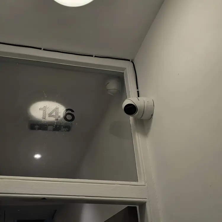 CCTV bullet camera installed above shop entrance in Twickenham TW1