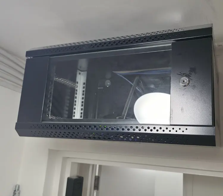Locked wall-mounted rack cabinet housing CCTV DVR recorder at commercial premises in Clapham Junction SW11 — professional installation by cctvcam.co.uk