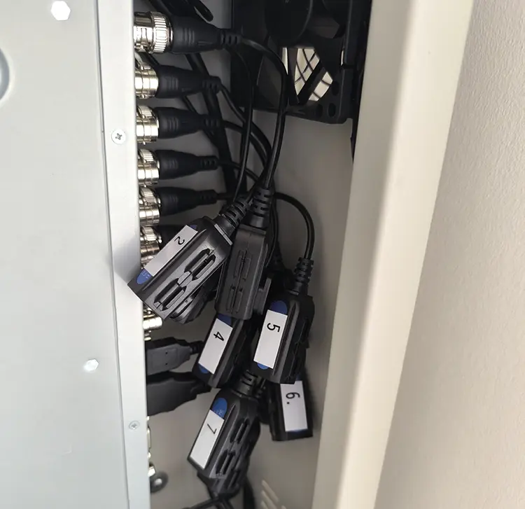 Numbered BNC balun connections inside CCTV DVR cabinet at commercial property in Dulwich SE22