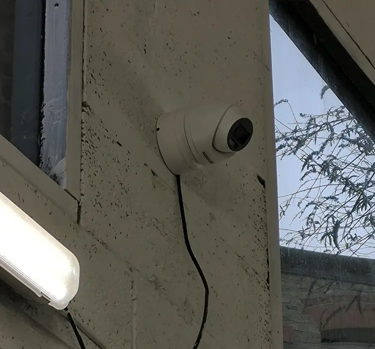 Hikvision dome camera installed on concrete wall in commercial warehouse in West Norwood SE27
