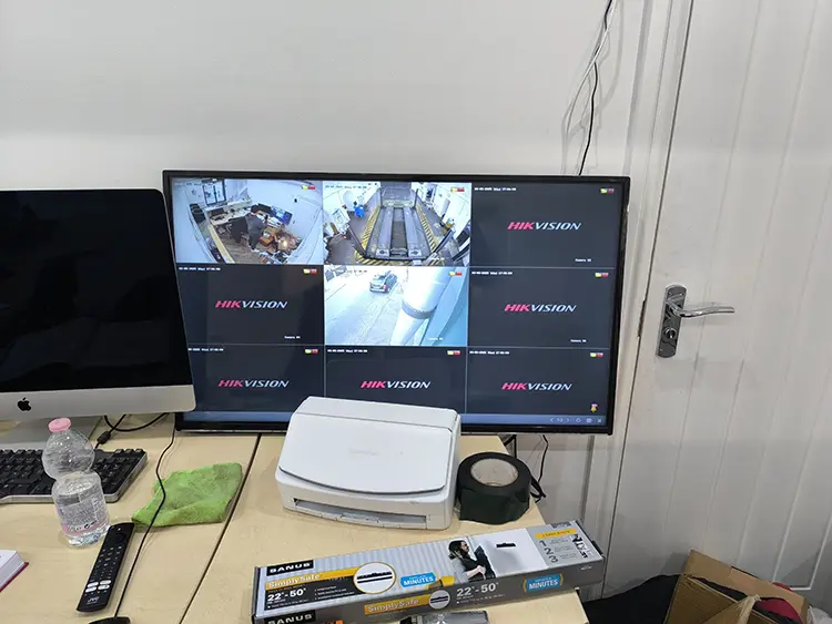 Commercial Hikvision CCTV monitor displaying 9-camera live footage in business premises in West Norwood SE27