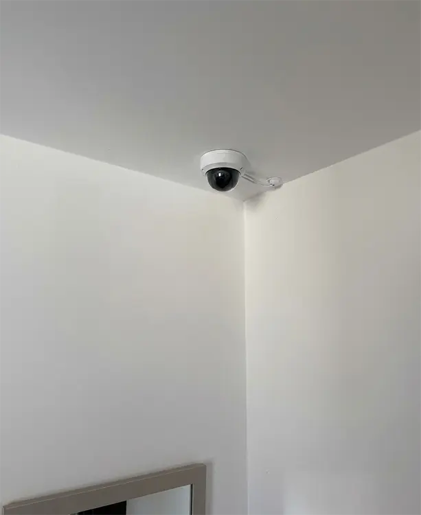 Dome CCTV camera installed in ceiling corner in residential property in Cheam SM3