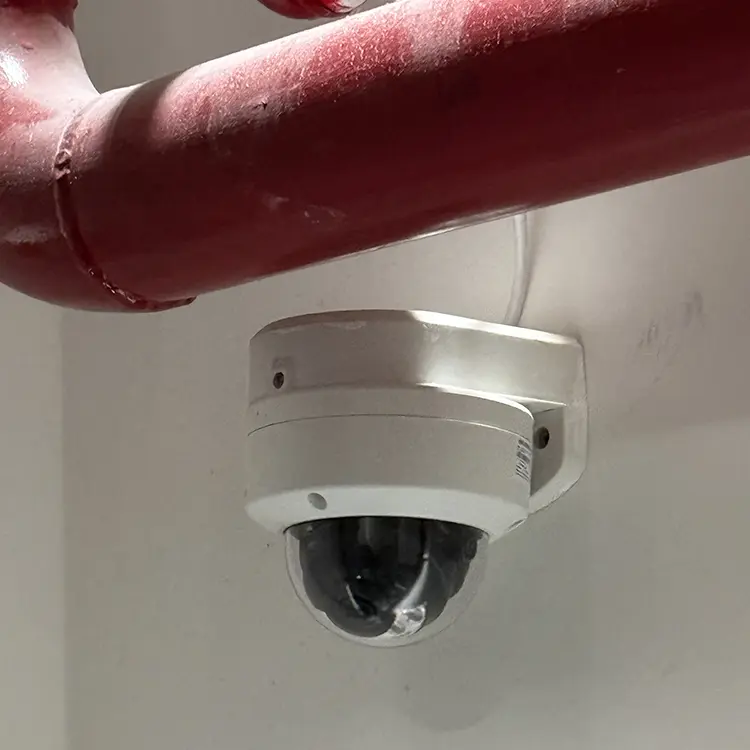 Dome CCTV camera installed near industrial pipe in commercial property in Surbiton KT6