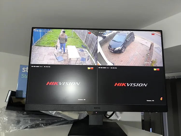 Hikvision 4-channel CCTV monitor showing live view of driveway and garden at residential property in Tolworth KT6