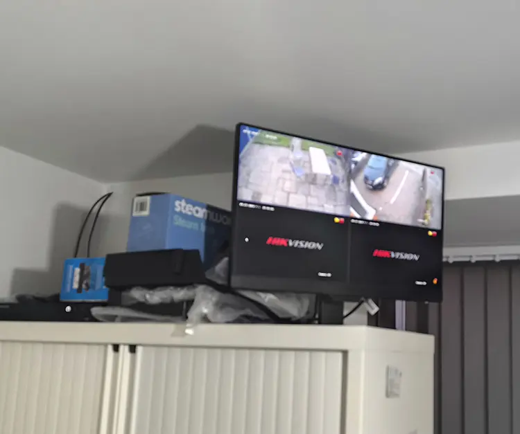 Hikvision CCTV monitor showing live camera feed installed at residential property in Tolworth KT6