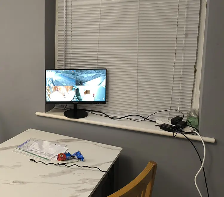 Home CCTV monitor displaying live camera footage installed in residential property in Croydon