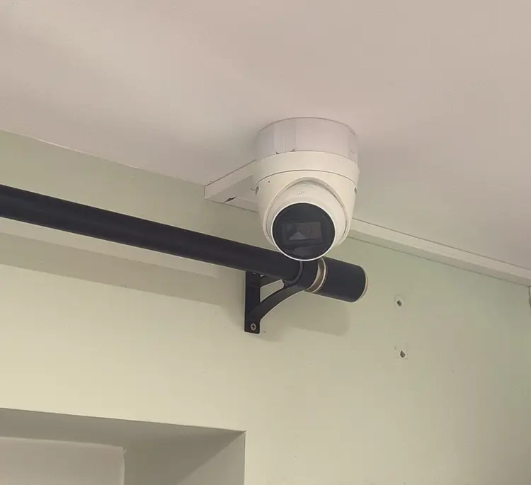 Indoor dome CCTV camera on bracket mount installed on ceiling at residential property in Tolworth KT6