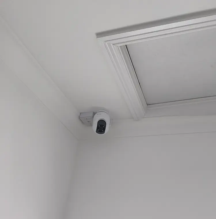Indoor PTZ security camera installed in ceiling corner of residential property in Dulwich SE22