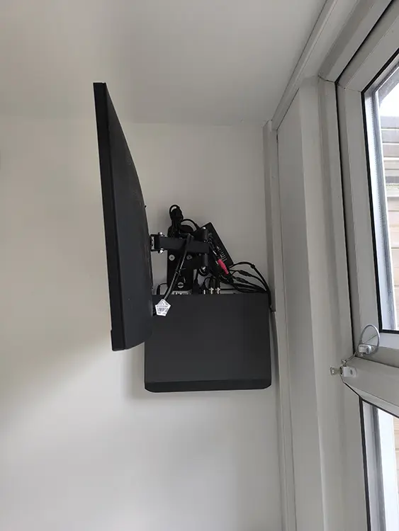 Wall-mounted CCTV monitor and DVR recorder installed on bracket at residential property in Tooting SW17 South London